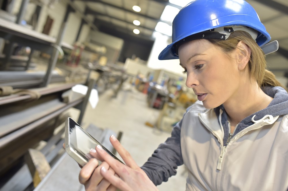 Woman engineer in steel plant checking production